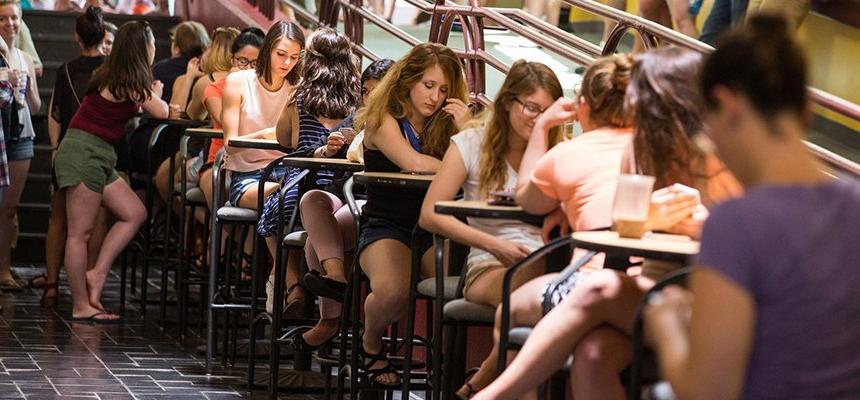 Students eating and studying at tables